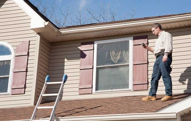 Roof inspection for ice dam damage on a Southern Minnesota home